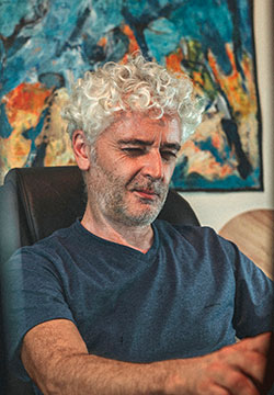 Paul Cavilla considering artwork in his studio
