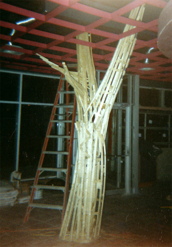 Hand-built tree sculpture extending through a Toronto café interior